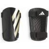 Futbalový chránič ADIDAS-TIRO SG TRN BLACK/GOLDMT/WHITE Čierna M 25/26 Futbalový chránič ADIDAS-TIRO SG TRN BLACK/GOLDMT/WHITE Čierna M 25/26
