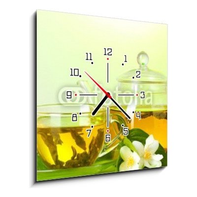 Obraz s hodinami 1D - 50 x 50 cm - tea with jasmine in cup and teapot on table on green background čaj s jasmínem v šálku a čajová konvice na stole na zeleném pozadí – Zboží Mobilmania