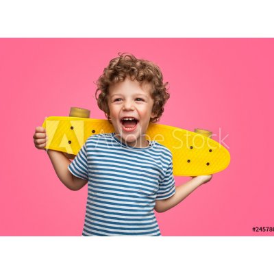 WEBLUX 245786759 Fototapeta plátno Happy curly boy laughing and holding skateboard Šťastný kudrnatý chlapec se směje a drží skateboard rozměry 240 x 174 cm – Zboží Mobilmania
