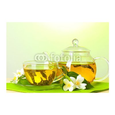 WEBLUX 42216193 Fototapeta plátno tea with jasmine in cup and teapot on table on green background čaj s jasmínem v šálku a čajová konvice na stole na zeleném pozadí rozměry 174 x 120 cm – Zboží Mobilmania