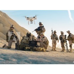 WEBLUX 164038449 Fototapeta vliesová Soldiers are Using Drone for Scouting During Military Operation in the Desert. Vojáci používají dron ke skautingu během vojenské op rozměry 100 x 73 cm