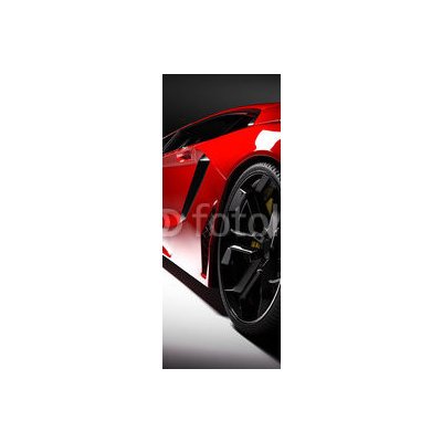 WEBLUX 115248334 Samolepka na lednici fólie Red fast sports car in spotlight Červené rychlé sportovní auto v reflektoru černé pozadí. Lesklý nový luxusní. rozměry 80 x 200 cm