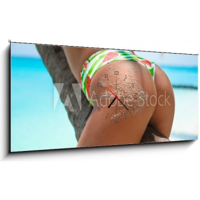Obraz s hodinami 1D panorama - 120 x 50 cm - Outdoor Closeup of Fit buttocks. Fitness woman on a palm tree. Sexy Ass over exotic beach. Sporty concept. Summertime vacati