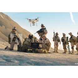 WEBLUX 164038449 Fototapeta vliesová Soldiers are Using Drone for Scouting During Military Operation in the Desert. Vojáci používají dron ke skautingu během vojenské op rozměry 145 x 100 cm