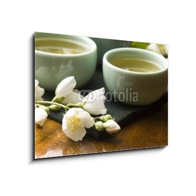 Skleněný obraz 1D - 100 x 70 cm - Green tea with jasmine in cup and teapot on wooden table Zelený čaj s jasmínem v šálku a konvici na dřevěném stole – Zbozi.Blesk.cz