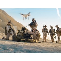 WEBLUX 164038449 Fototapeta vliesová Soldiers are Using Drone for Scouting During Military Operation in the Desert. Vojáci používají dron ke skautingu během vojenské op rozměry 270 x 200 cm