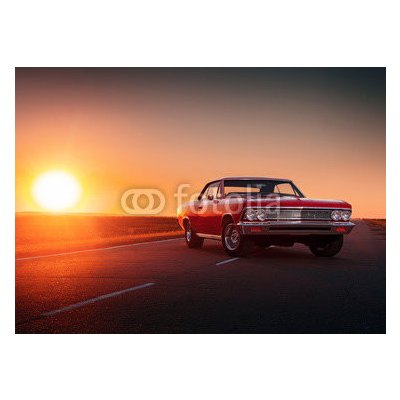 WEBLUX 109817494 Samolepka fólie Retro red car standing on asphalt road at sunset Retro červené auto stojí na asfaltové cestě při západu slunce rozměry 200 x 144 cm – Zbozi.Blesk.cz