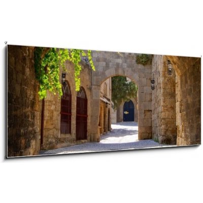 Obraz 1D panorama - 120 x 50 cm - Medieval arched street in the old town of Rhodes, Greece Středověká oblouková ulice ve starém městě Rhodos v Řecku – Zboží Mobilmania
