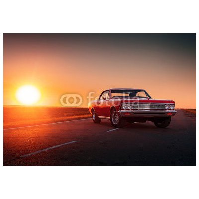 WEBLUX 109817494 Samolepka fólie Retro red car standing on asphalt road at sunset Retro červené auto stojí na asfaltové cestě při západu slunce rozměry 145 x 100 cm – Zbozi.Blesk.cz