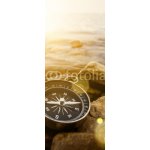 WEBLUX 60262537 Samolepka na lednici fólie compass on the shore at sunrise kompas na pobřeží při východu slunce rozměry 80 x 200 cm