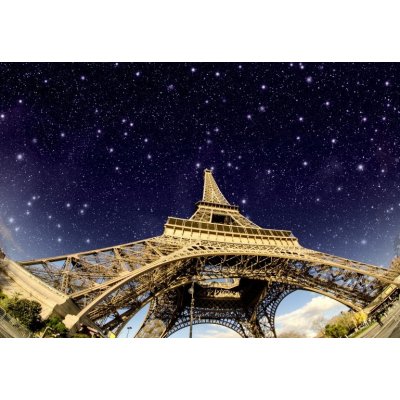 WEBLUX 41726056 Fototapeta vliesová Stars and Night Sky above Eiffel Tower in Paris Hvězdy a noční obloha nad Eiffelovou věží v Paříži rozměry 145 x 100 cm – Zboží Mobilmania