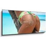 Skleněný obraz 1D panorama - 120 x 50 cm - Outdoor Closeup of Fit buttocks. Fitness woman on a palm tree. Sexy Ass over exotic beach. Sporty concept. Summertime vacation – Hledejceny.cz