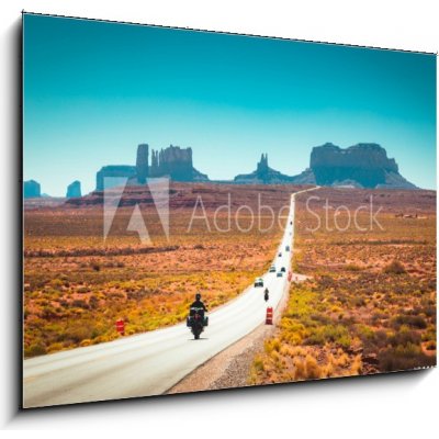 Skleněný obraz 1D - 100 x 70 cm - Biker on Monument Valley road at sunset, USA Motorkář na silnici Monument Valley při západu slunce, USA – Zboží Mobilmania