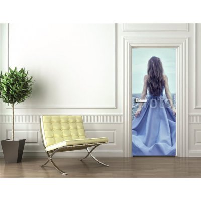 Weblux 70223866 Samolepka na dveře fólie Back view of standing young woman in blue dress Zadní pohled na stojící mladá žena v modrých šatech rozměry 90 x 220 cm