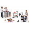 Set kuchynka ostrovček a práčovňa Kitchen Island 360° Smoby s elektronickým vysávačom a vozík so zákuskami