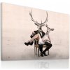 Moderný obraz na plátne – Pár jeleňov v elegantnej póze na kresle Veľkosť: 100x70 cm