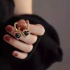 Swarovski e. zlaté náušnice polkruhy Love Enigma, čierne see3879