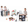 Set kuchynka ostrovček a práčovňa Kitchen Island 360° Smoby s elektronickým vysávačom a vozík so zákuskami